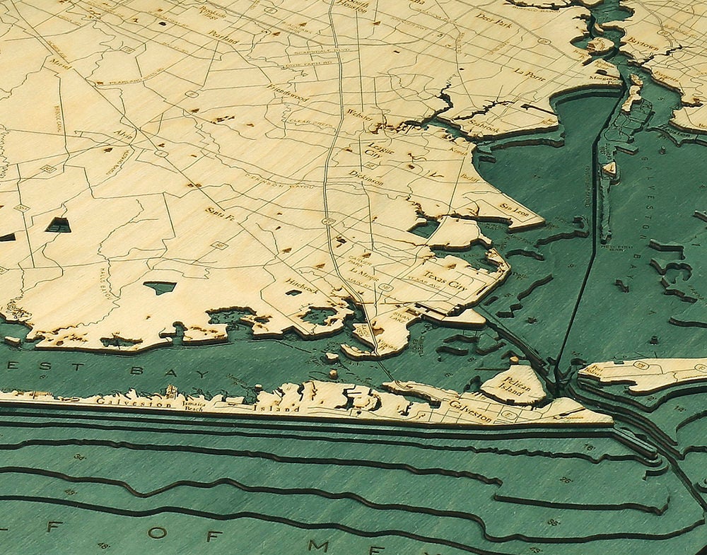 Houston, Texas 3D layered wood map in laser-cut Baltic birch, shown framed against a light wall