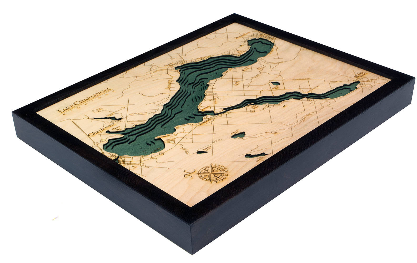 Lake Charlevoix, Michigan 3D layered wood map in laser-cut Baltic birch, shown framed against a light wall