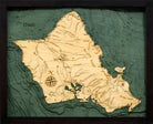Oahu, Hawaii 3D layered wood map in laser-cut Baltic birch, shown framed against a light wall