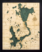 Lake Okoboji, Iowa 3D layered wood map in laser-cut Baltic birch, shown framed against a light wall