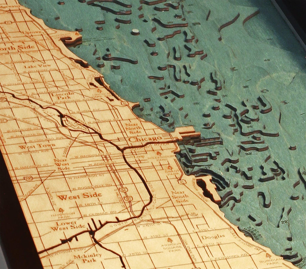 Chicago, Illinois 3D layered wood map in laser-cut Baltic birch, shown framed against a light wall