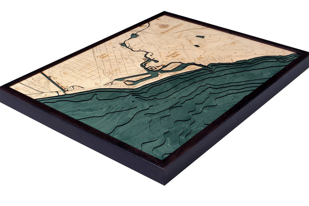 Newport Beach, California 3D layered wood map in laser-cut Baltic birch, shown framed against a light wall