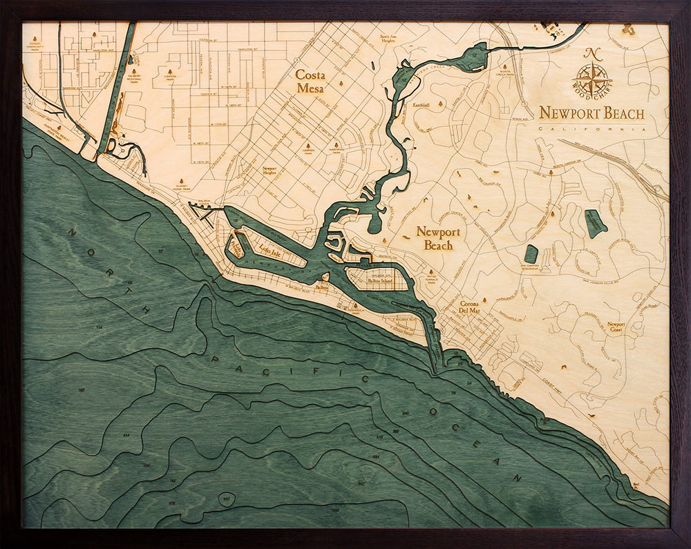Newport Beach, California 3D layered wood map in laser-cut Baltic birch, shown framed against a light wall