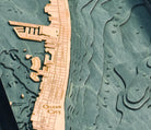 Ocean City, Maryland 3D layered wood map in laser-cut Baltic birch, shown framed against a light wall