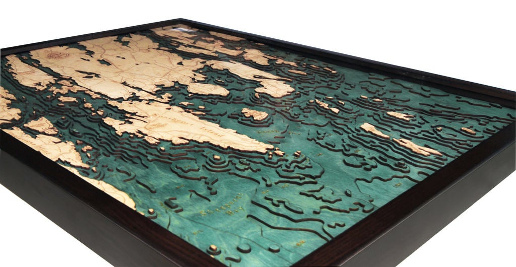Boothbay Harbor, Maine 3D layered wood map in laser-cut Baltic birch, shown framed against a light wall