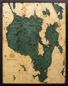 Sebago Lake, Maine 3D layered wood map in laser-cut Baltic birch, shown framed against a light wall