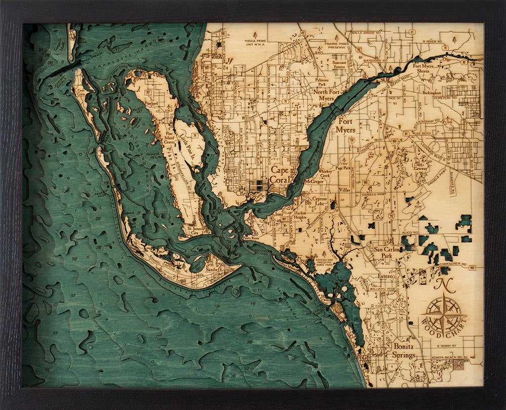 Fort Myers, Florida 3D layered wood map in laser-cut Baltic birch, shown framed against a light wall