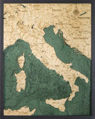 Italy 3D layered wood map in laser-cut Baltic birch, shown framed against a light wall