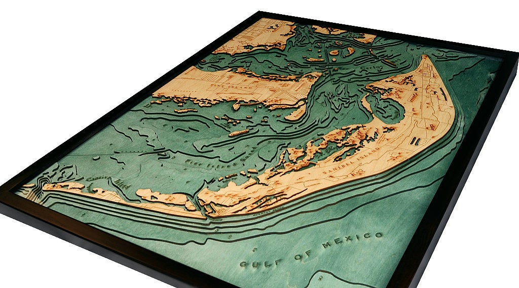 Sanibel Island, Florida 3D layered wood map in laser-cut Baltic birch, shown framed against a light wall