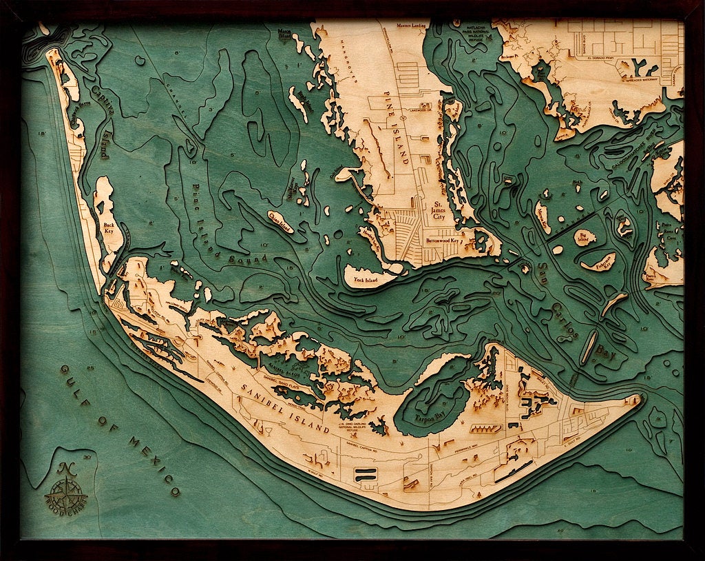 Sanibel Island, Florida 3D layered wood map in laser-cut Baltic birch, shown framed against a light wall