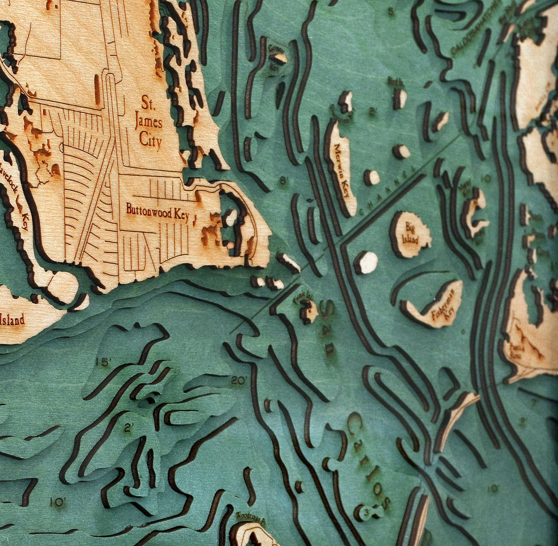 Sanibel Island, Florida 3D layered wood map in laser-cut Baltic birch, shown framed against a light wall