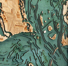 Sanibel Island, Florida 3D layered wood map in laser-cut Baltic birch, shown framed against a light wall