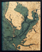 Tampa Bay, Florida 3D layered wood map in laser-cut Baltic birch, shown framed against a light wall