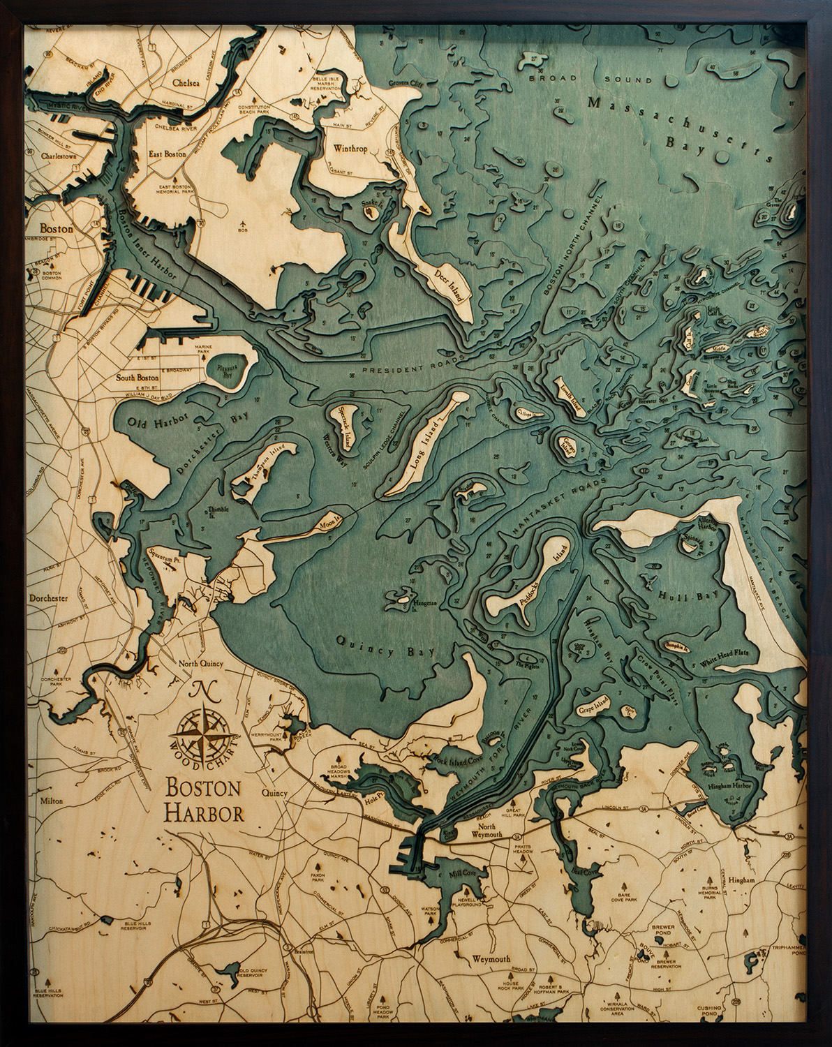 Boston Harbor, Massachusetts 3D layered wood map in laser-cut Baltic birch, shown framed against a light wall