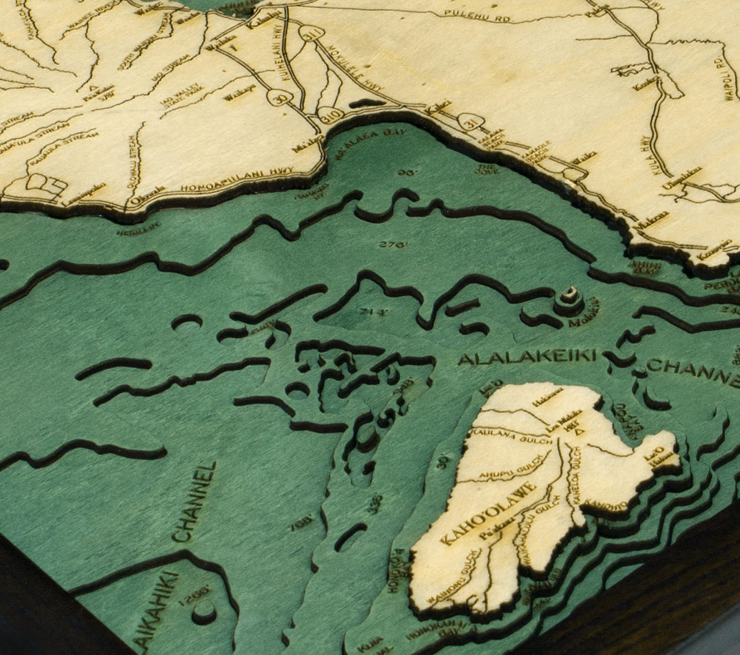 Maui, Hawaii 3D layered wood map in laser-cut Baltic birch, shown framed against a light wall