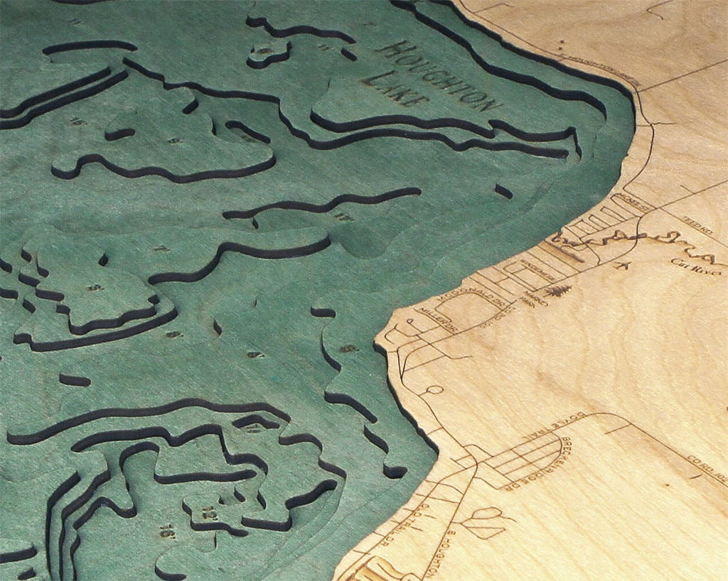 Houghton Lake, Michigan 3D layered wood map in laser-cut Baltic birch, shown framed against a light wall