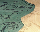 Houghton Lake, Michigan 3D layered wood map in laser-cut Baltic birch, shown framed against a light wall