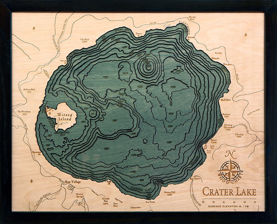 Crater Lake, Oregon 3D layered wood map in laser-cut Baltic birch, shown framed against a light wall