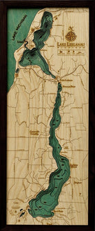Lake Leelanau, Michigan 3D layered wood map in laser-cut Baltic birch, shown framed against a light wall