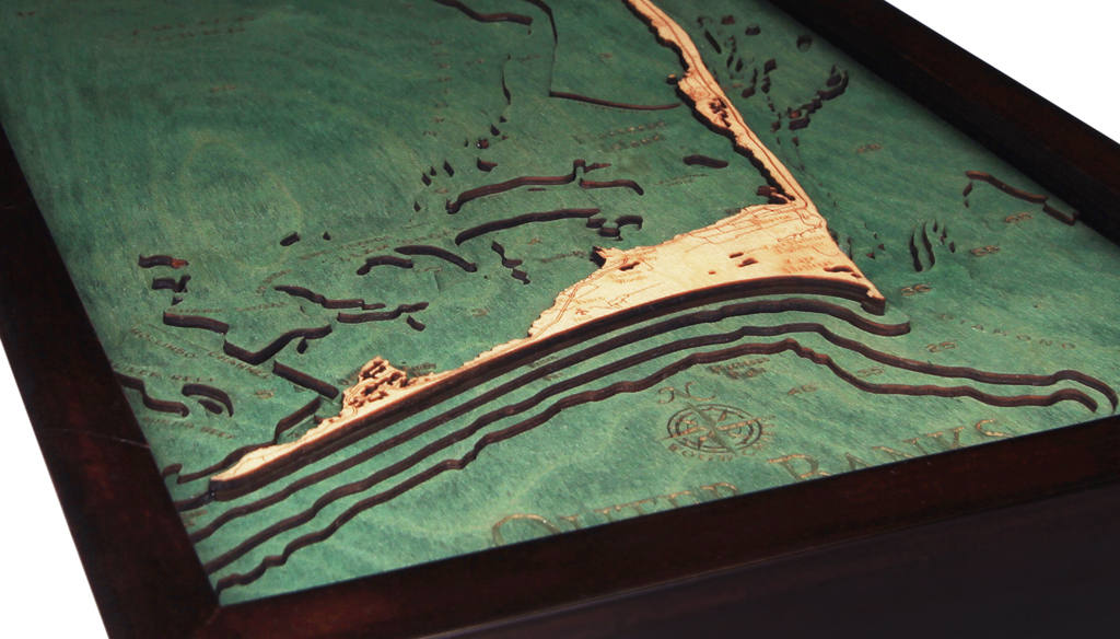 Outer Banks, North Carolina 3D layered wood map in laser-cut Baltic birch, shown framed against a light wall