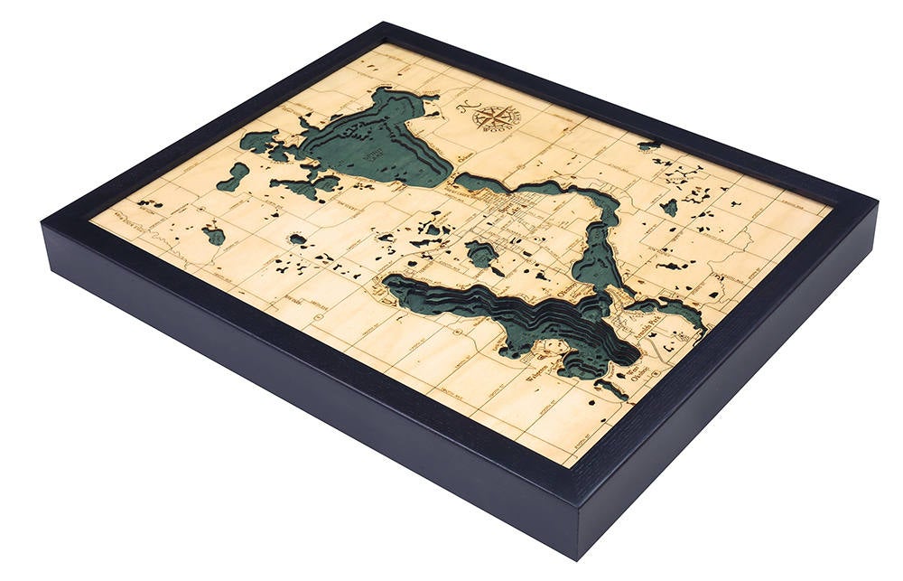 Lake Okoboji, Iowa 3D layered wood map in laser-cut Baltic birch, shown framed against a light wall