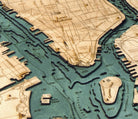 Manhattan, New York 3D layered wood map in laser-cut Baltic birch, shown framed against a light wall