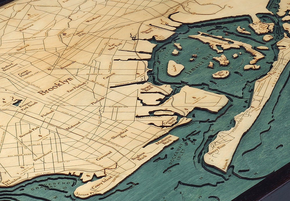Brooklyn, New York 3D layered wood map in laser-cut Baltic birch, shown framed against a light wall