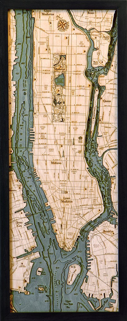 Manhattan, New York 3D layered wood map in laser-cut Baltic birch, shown framed against a light wall