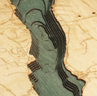 Canandaigua Lake, New York 3D layered wood map in laser-cut Baltic birch, shown framed against a light wall