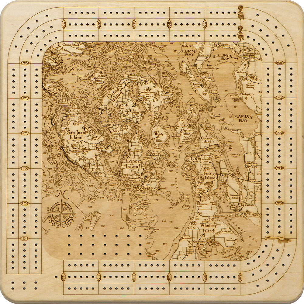 San Juan Islands, Washington wood cribbage board in laser-cut Baltic birch, shown framed against a light wall