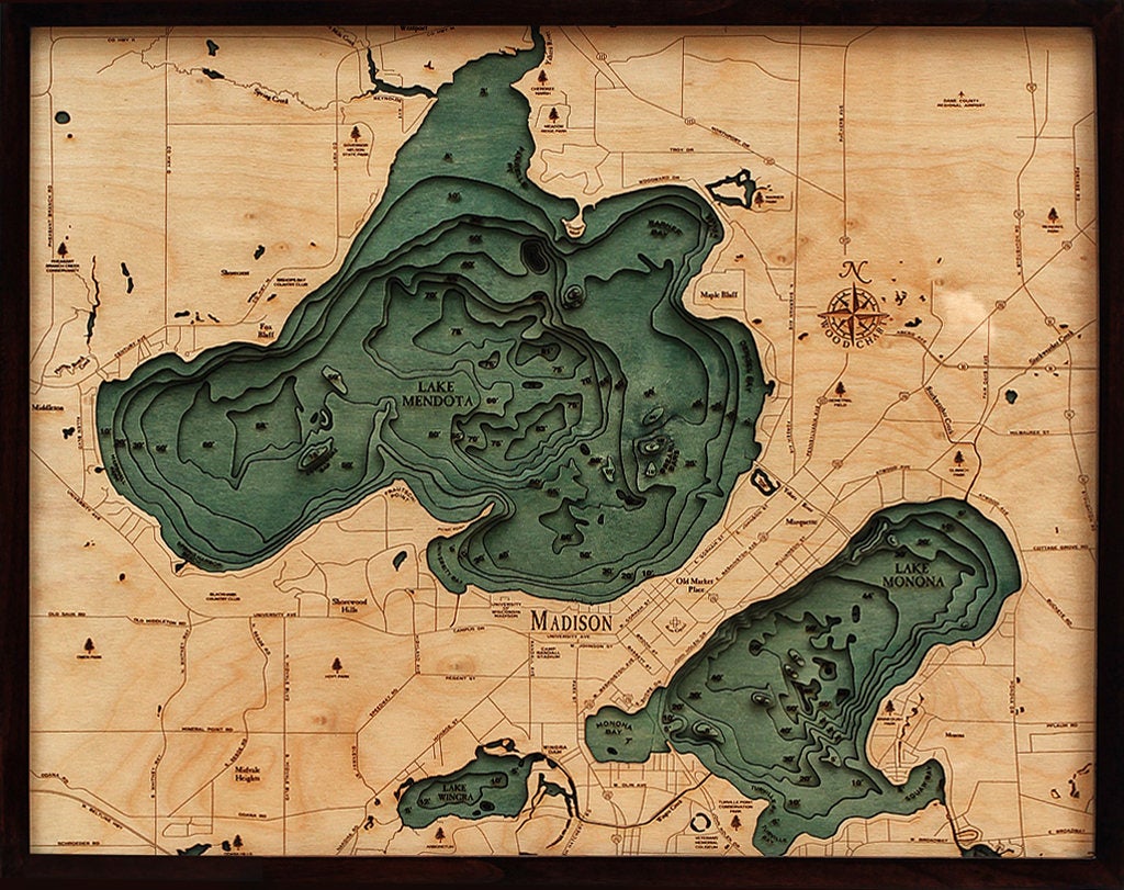 Lake Mendota & Monona, Wisconsin 3D layered wood map in laser-cut Baltic birch, shown framed against a light wall