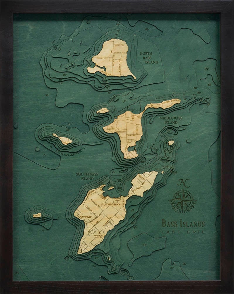 Put-in-Bay, Ohio 3D layered wood map in laser-cut Baltic birch, shown framed against a light wall