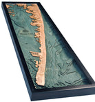 Ocean City, Maryland 3D layered wood map in laser-cut Baltic birch, shown framed against a light wall