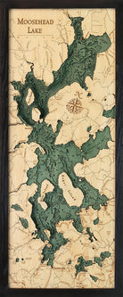Moosehead Lake, Maine 3D layered wood map in laser-cut Baltic birch, shown framed against a light wall