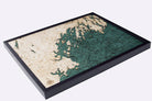 Portland, Maine 3D layered wood map in laser-cut Baltic birch, shown framed against a light wall