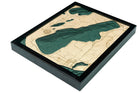Crystal Lake, Michigan 3D layered wood map in laser-cut Baltic birch, shown framed against a light wall