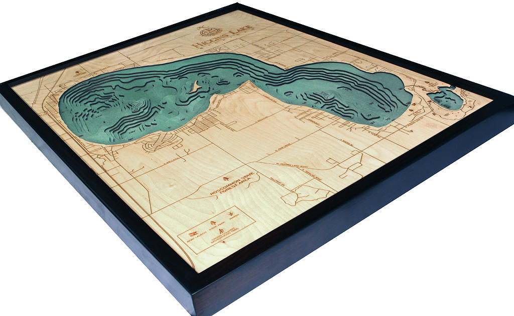 Higgins Lake, Michigan 3D layered wood map in laser-cut Baltic birch, shown framed against a light wall