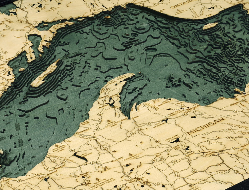 Lake Superior, Michigan 3D layered wood map in laser-cut Baltic birch, shown framed against a light wall
