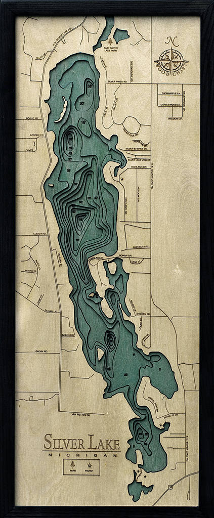 Silver Lake, Michigan 3D layered wood map in laser-cut Baltic birch, shown framed against a light wall