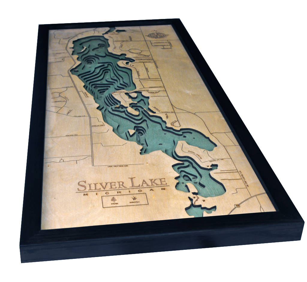 Silver Lake, Michigan 3D layered wood map in laser-cut Baltic birch, shown framed against a light wall