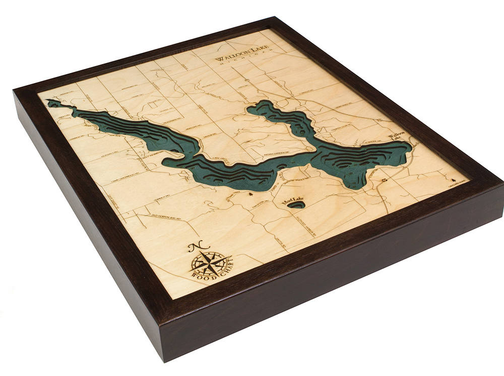 Walloon Lake, Michigan 3D layered wood map in laser-cut Baltic birch, shown framed against a light wall