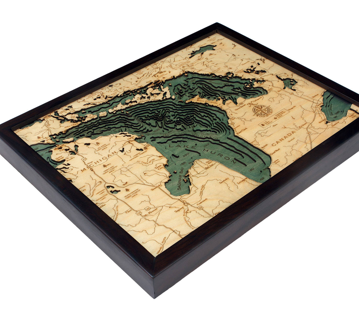 Lake Huron, Michigan 3D layered wood map in laser-cut Baltic birch, shown framed against a light wall
