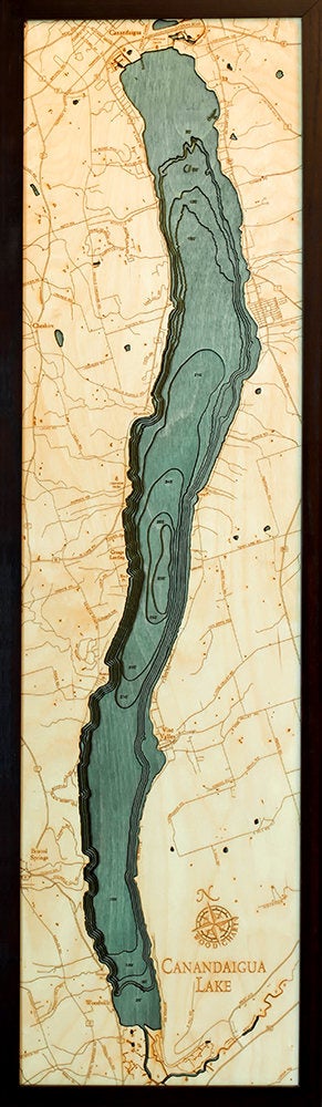 Canandaigua Lake, New York 3D layered wood map in laser-cut Baltic birch, shown framed against a light wall