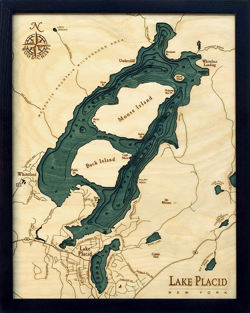 Lake Placid, New York 3D layered wood map in laser-cut Baltic birch, shown framed against a light wall