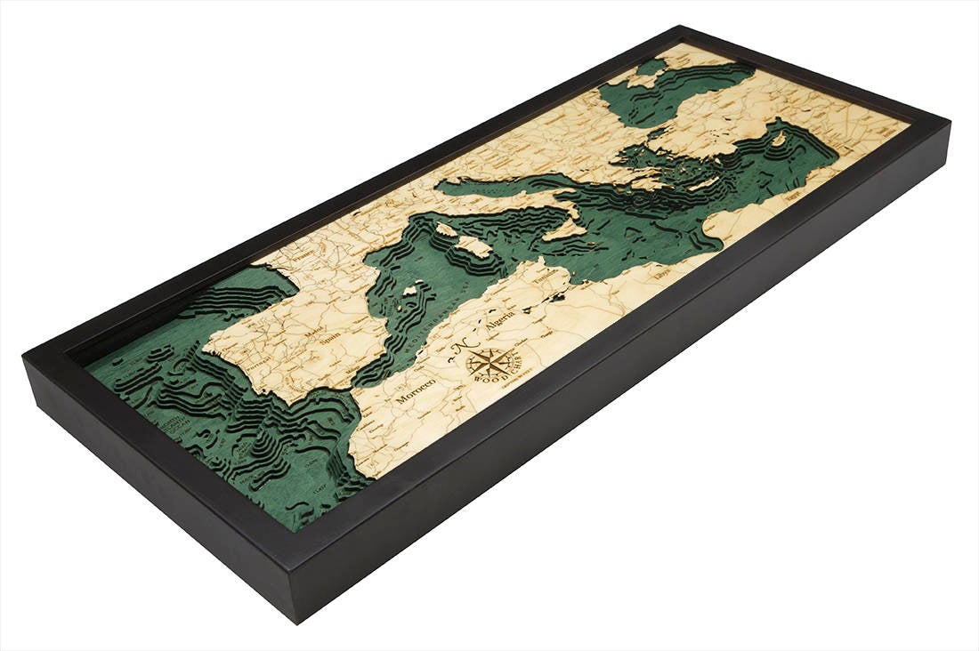 Mediterranean Sea 3D layered wood map in laser-cut Baltic birch, shown framed against a light wall