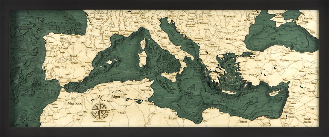 Mediterranean Sea 3D layered wood map in laser-cut Baltic birch, shown framed against a light wall