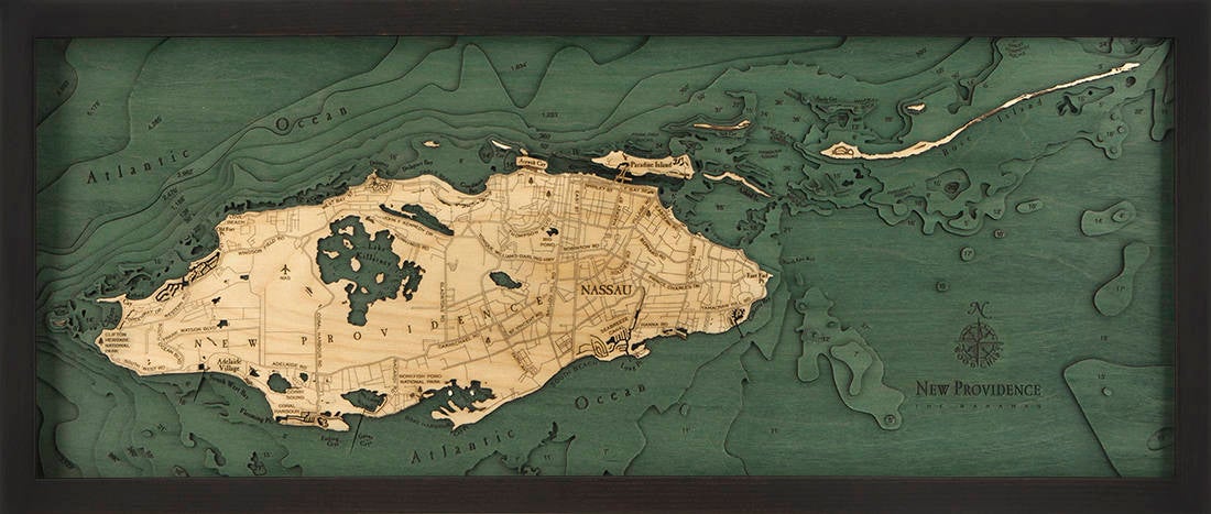 Nassau, Bahamas 3D layered wood map in laser-cut Baltic birch, shown framed against a light wall