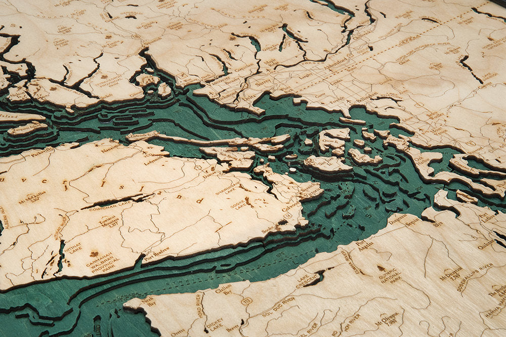 Salish Sea, Washington 3D layered wood map in laser-cut Baltic birch, shown framed against a light wall