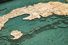 Cuba 3D layered wood map in laser-cut Baltic birch, shown framed against a light wall