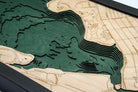 White Rock Lake, Texas 3D layered wood map in laser-cut Baltic birch, shown framed against a light wall